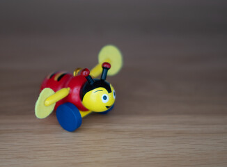 Selective focus shot of a buzzy bee toy on a wooden surface