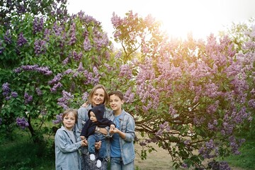 Obraz premium Portrait of mother and three sons in the park 