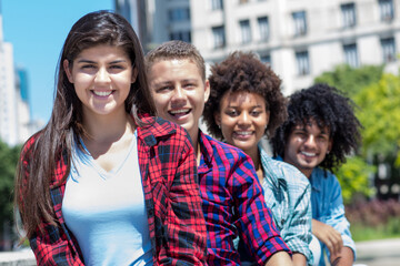 Spanish teen with group of multicultural young adults in a row