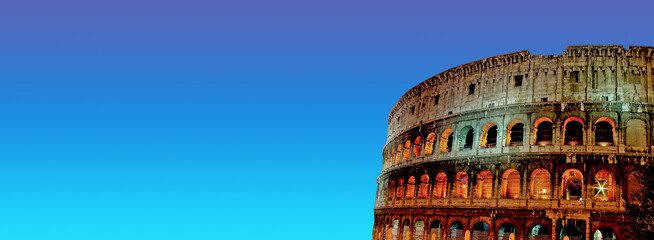 Banner with front view of wonderful ancient Colosseum at night illumination and sunset blue and...