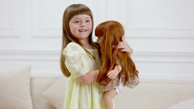 child dancing with his doll