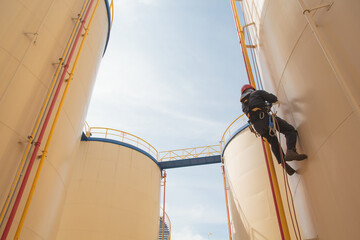 Male  worker rope access  inspection of thickness storage tank