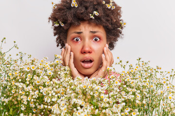 Close up shot of worried shocked African American womangrabs face gasps and has shortness of breath...