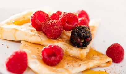 pancakes with raspberries, blackberries and honey