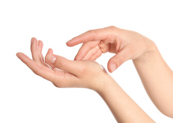 Young woman applying something onto her hands on white background, closeup