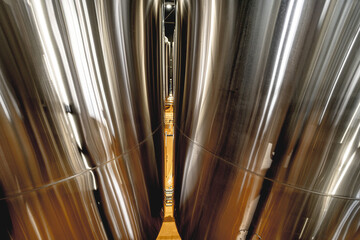 Obraz premium Rows of steel tanks for beer fermentation and maturation in a craft brewery