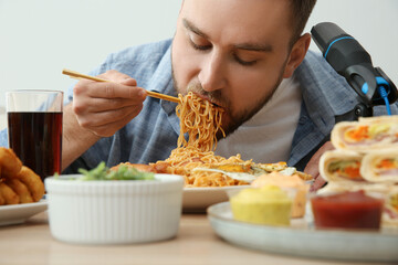 Food blogger eating in front of microphone at table, closeup. Mukbang vlog