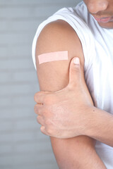 adhesive bandage on young man's arm with copy space 