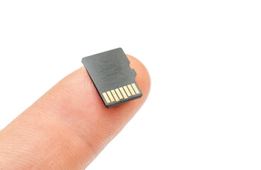 Micro SD card on human finger. Close up. Isolated on white.