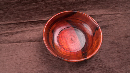 Empty wooden bowl and wooden spoon isolated with copy space.