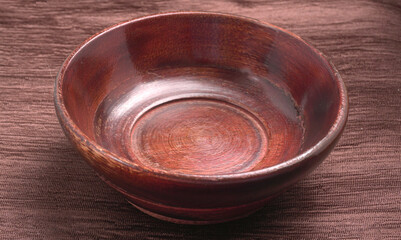 Empty wooden bowl and wooden spoon isolated with copy space.