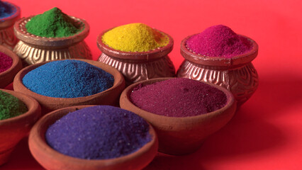 Diwali Festival showing Colourful rangoli in bowls,clay lamp or diya on background