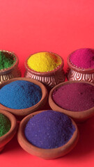 Diwali Festival showing Colourful rangoli in bowls,clay lamp or diya on background