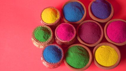 Diwali Festival showing Colourful rangoli in bowls,clay lamp or diya on background