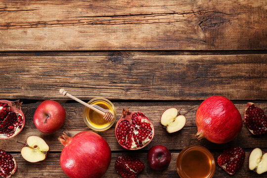 Flat lay composition with Rosh Hashanah holiday attributes on wooden table. Space for text