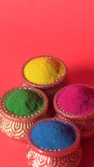 Diwali Festival showing Colourful rangoli in bowls,clay lamp or diya on background