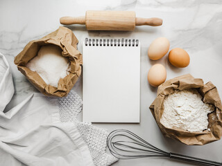 Cooking homemade bakery products. Close-up, view from above, wooden board. White, isolated background. Delicious and healthy food concept