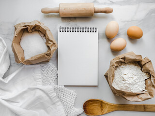 Cooking homemade bakery products. Close-up, view from above, wooden board. White, isolated background. Delicious and healthy food concept