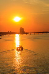 Modern yacht sailing on the Dnieper river at sunset in Dnipro, Ukraine