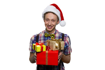 Portrait of happy smiling boy is holding gift boxes for xmas.