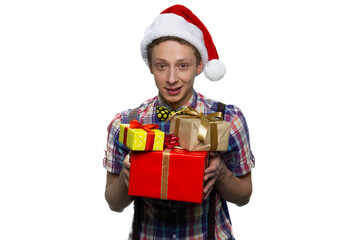 Handsome teenage boy is giving presents for xmas.
