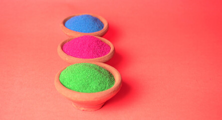 Diwali Festival showing Colourful rangoli in bowls,clay lamp or diya on background