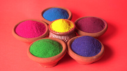 Diwali Festival showing Colourful rangoli in bowls,clay lamp or diya on background