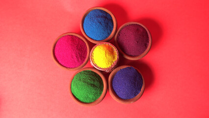 Diwali Festival showing Colourful rangoli in bowls,clay lamp or diya on background