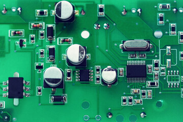 Electronic circuit board close-up. Circuit board background, plate of electronic components. Toned image, film grain