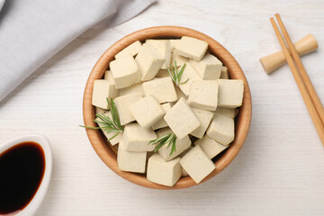 Fototapeta na wymiar Delicious tofu with rosemary served on white wooden table, flat lay