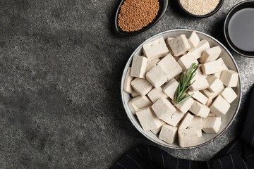 Delicious tofu with rosemary served on grey table, flat lay. Space for text