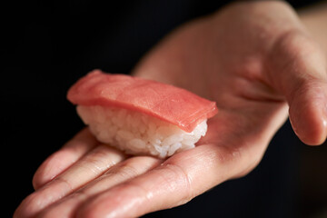 fresh tuna sushi in hand