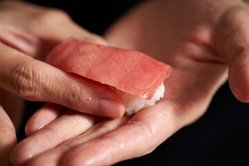 Hand making fresh tuna sushi