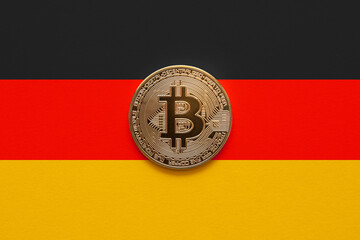 One bitcoin on a German flag background. German law allowing institutional funds to invest in cryptocurrencies on August 2021