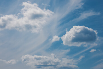 Blue sky with fluffy white clouds. Natural background.
