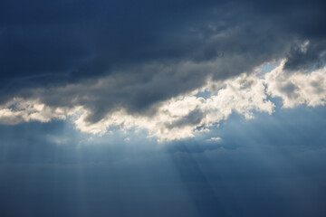 Dramatic sky with stormy clouds and sun rays. Epic view of natural background.
