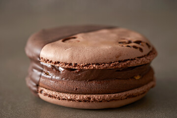 Chocolate cream macarons on gray background 