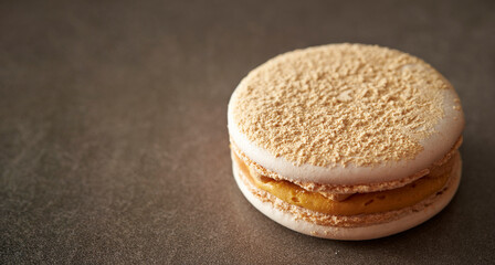 Creamy macarons on a gray background 