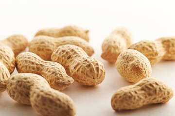 raw peanuts on a white background