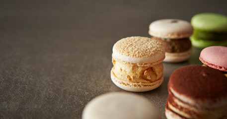 Different types of macarons on a gray background