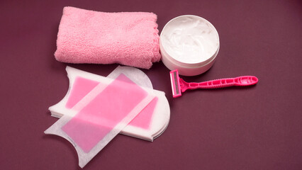 Set of different means for epilation on a colored background. Removal of unwanted hair. Modern epilator, wax strips, razor.
