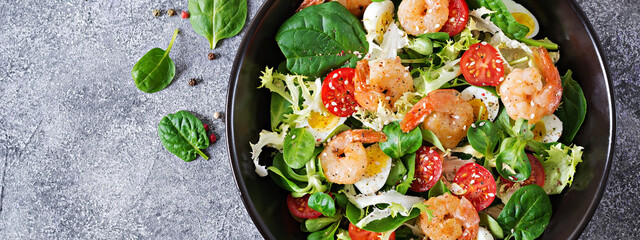 Healthy salad plate. Fresh seafood recipe. Grilled shrimps and fresh vegetable salad and egg. Grilled prawns. Healthy food. Flat lay. Top view