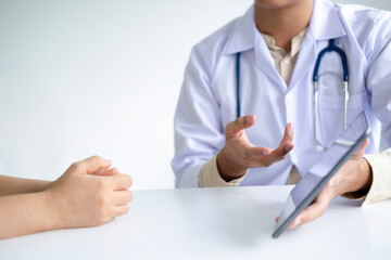 Doctor comforting patient at consulting room.