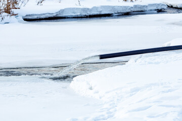 Obraz premium drainage of water into the river from the production of the ski track