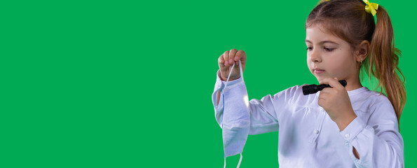 Very attentive girl in white t-shirt holding flashlight in her hand and shone the light on the white medical mask.