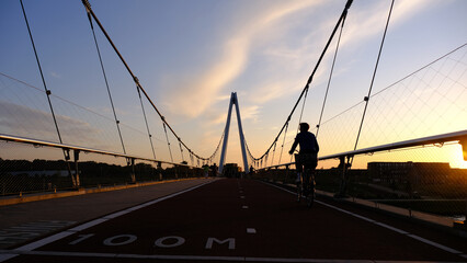 a cyclist on the Dafne Schippersbrug in Utrecht in the setting sun