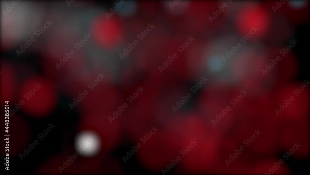 Poster abstract video background made of blurred flying or floating red circles.