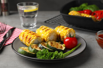 Delicious grilled vegetables served on grey table