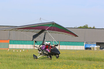 	
Ultralight airplane on a grass airfield
