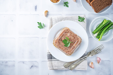 Meat aspic in a plate with mustard